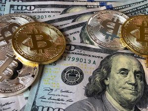 Gold topples dollar, crypto towards best week in over two years